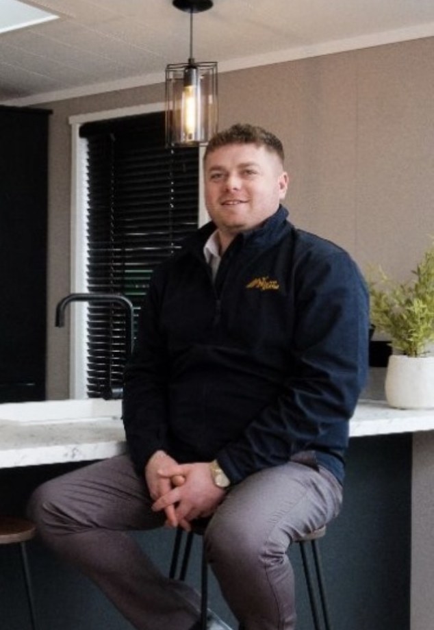 Shane of My Leisure Home, seated at a lodge kitchen breakfast bar